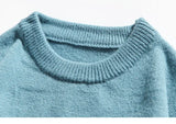 grunge knit sweater with heavyweight fabric, layered urban look for cold weather, street fashion menswear trend for seasonal 
