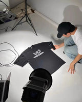 Gothic angel tee with dark feathered wing and flame text