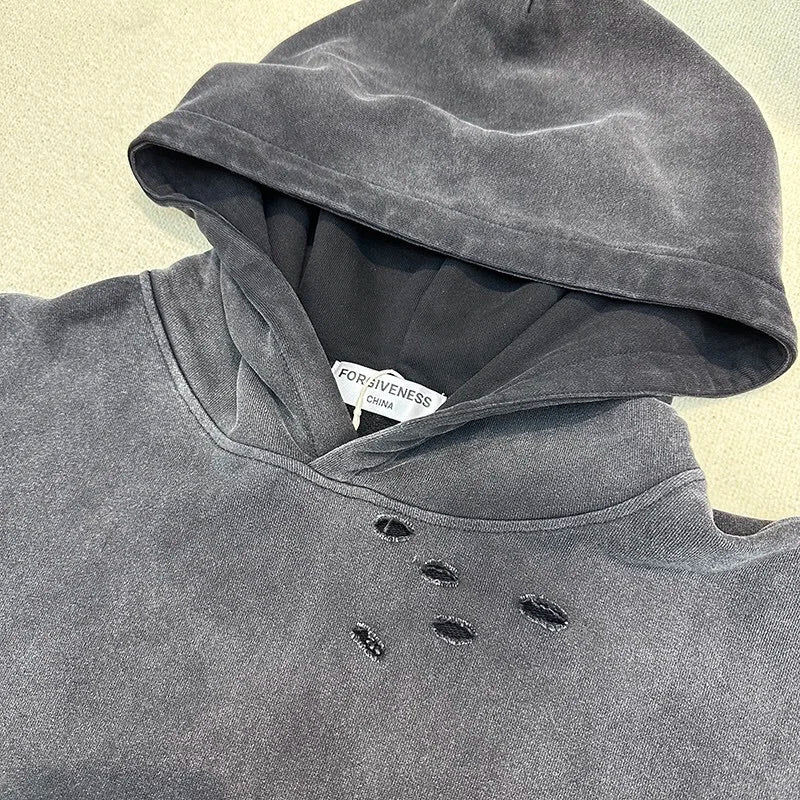 Grunge goth hoodie with ripped details and dark punk energy