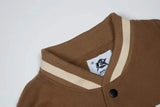 panel varsity outerwear, 2025 trend, for men, fall streetwear outfit, oversized style, layered fashion, modern aesthetic, graphic detail